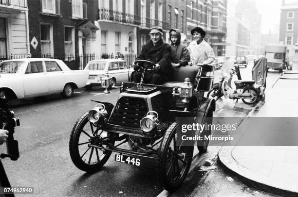 Spike Milligan off for a drive in the rain in a 1901 Durkopp loaned from the Montague Motor Museum. Spike will be driving it in the London to...