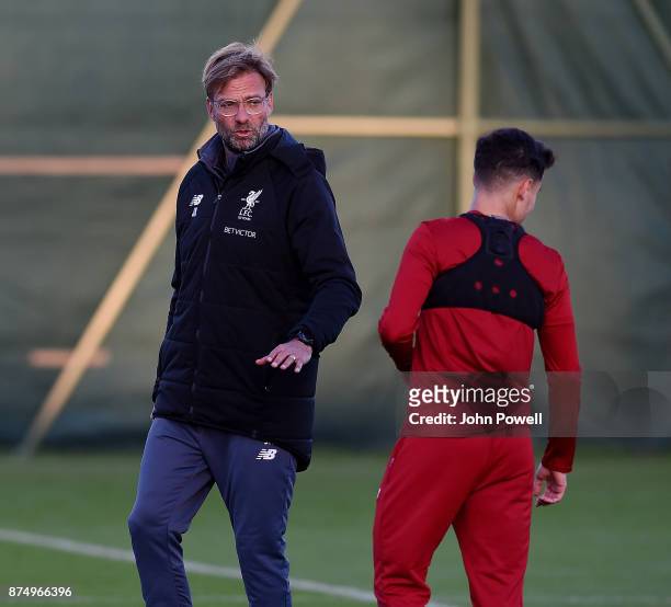 Jurgen Klopp manager of Liverpool talks with Philppe Coutinho during a training session at Melwood Training Ground on November 16, 2017 in Liverpool,...