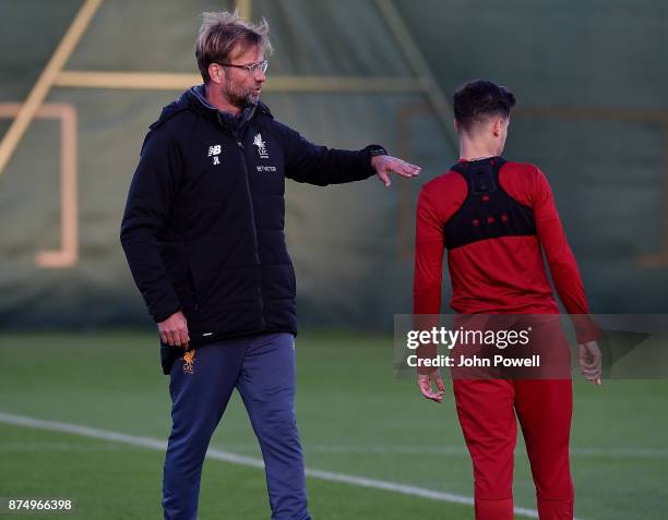 Jurgen Klopp manager of Liverpool talks with Philppe Coutinho during a training session at Melwood Training Ground on November 16, 2017 in Liverpool,...