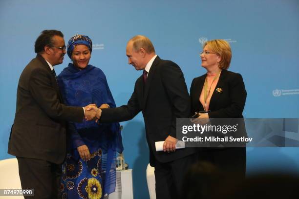 Russian President Vladimir Putin greets WHO Director Tedros Adhanom Ghebbreyesus and UN Deputy Secretary-General Amina Muhammad as Russian Health...