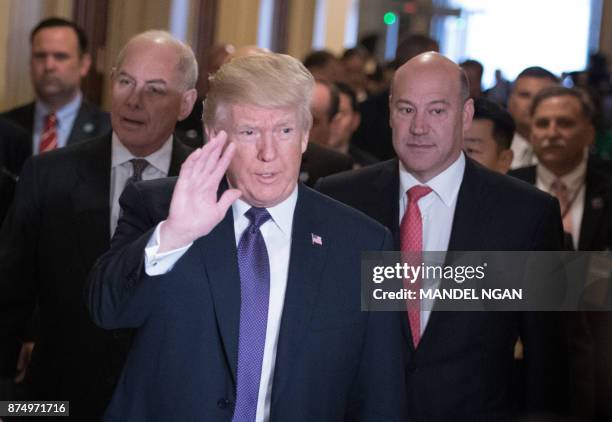 President Donald Trump along with White House Chief of Staff John Kelly and Director of the National Economic Council Gary Cohn arrives for a meeting...