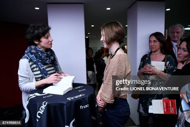 French writer Alice Zeniter signs her book after being awarded the Prix Goncourt des Lyceens for her novel "The Art of Losing" on November 16 in...