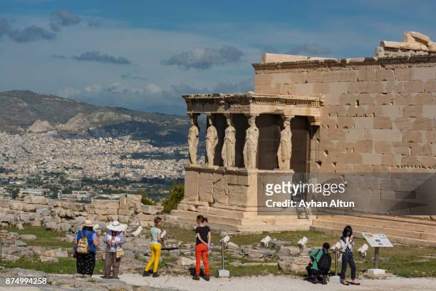 the erechtheion temple and the porch of the caryatids in athens,greece - poseidon sculpture stock pictures, royalty-free photos & images