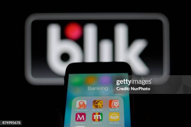 Smartphone with banking applications is seen with the Blik mobile payments logo in the background in this photo illustration on November 15, 2017....
