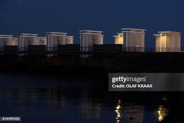 Picture taken on November 16, 2017 shows the art project Gates of Light illuminating the Afsluitdijk near Kornwerderzand, The Netherlands. The...
