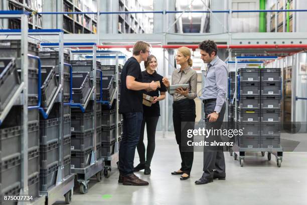 team meeting in distribution warehouse - factory ipad stock pictures, royalty-free photos & images