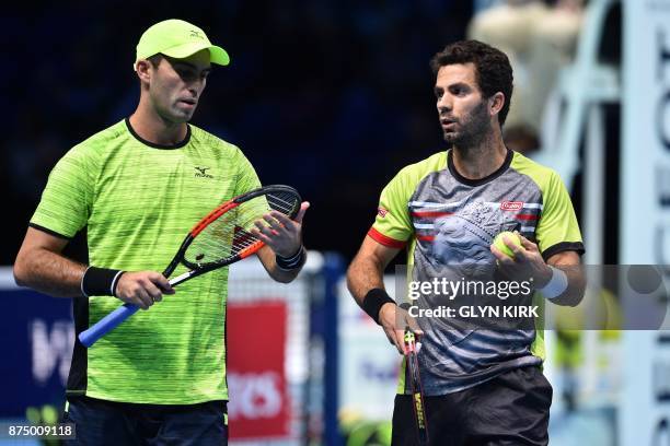 Netherlands' Jean-Julien Rojer and Romania's Horia Tecau chat during their men's doubles round-robin match against US player Ryan Harrison and New...