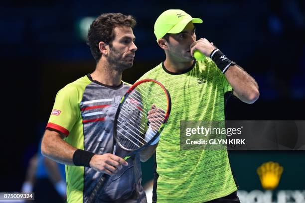 Netherlands' Jean-Julien Rojer and Romania's Horia Tecau chat during their men's doubles round-robin match against US player Ryan Harrison and New...