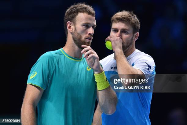 Player Ryan Harrison talks with New Zealand's Michael Venus during their men's doubles round-robin match against Netherlands' Jean-Julien Rojer and...