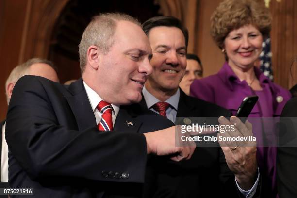 Rep. Evan Jenkins shows Majority Whip Steve Scalise something on his iPhone following the passage of the Tax Cuts and Jobs Act in the Rayburn Room at...