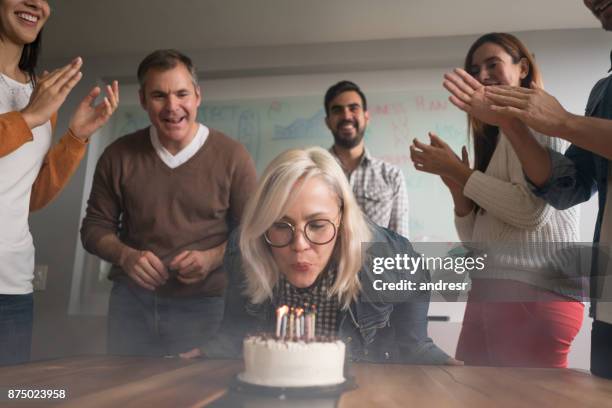 woman celebrating her birthday at the office - anniversary cake stock pictures, royalty-free photos & images