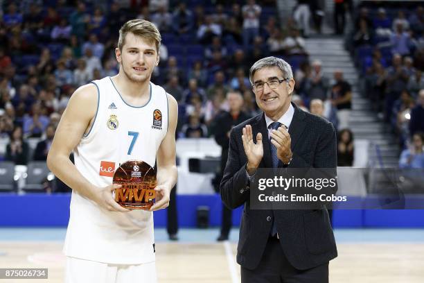 Luka Doncic, #7 of Real Madrid receives the October Euroleague MVP trophy from Jordi Bertomeu, President and CEO of Euroleague Basketball before the...