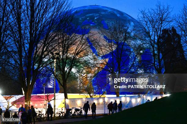 Mockup of a planet earth is displayed at the Rheinaue park during the COP23 United Nations Climate Change Conference in Bonn, Germany. / AFP PHOTO /...