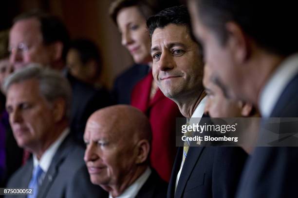 House Speaker Paul Ryan, a Republican from Wisconsin, center right, listens during a news conference with House Republican members after voting on...
