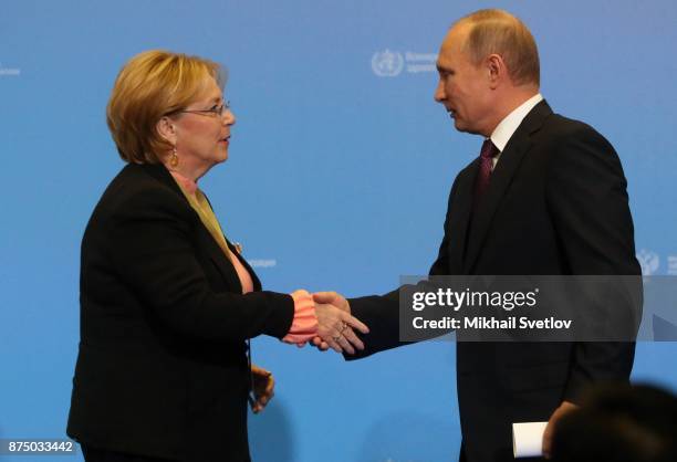 Russian President Vladimir Putin greets Russian Health Minister Veronika Skvortsova during fhe first WHO global ministerial conference ending TB in...