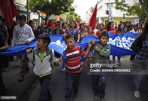 Some children participate with university students and members of social and indigenous groups in a protest demanding the resignation of Guatemalan...