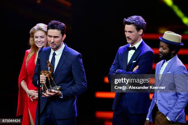 Palina Rojisnki, Simon Verhoeven, Florian David Fitz and Eric Kabongo pose with award at the Bambi Awards 2017 winners board at Stage Theater on...