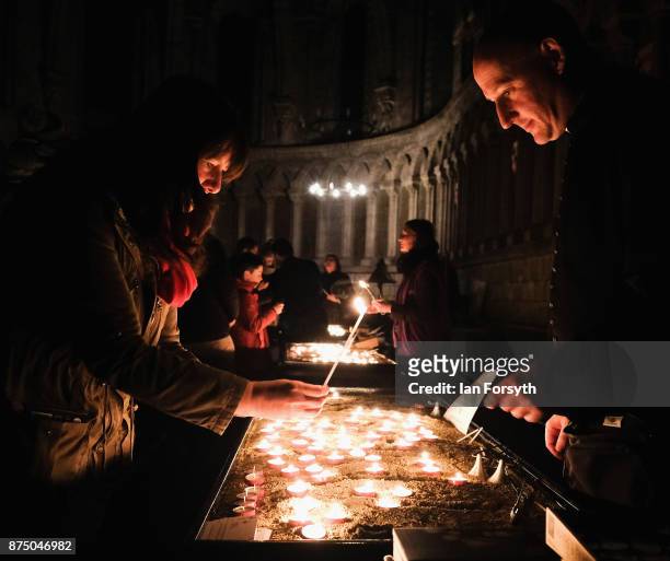 Visitors to Durham Cathedral during the opening evening of the Durham Lumiere event light candles on November 16, 2017 in Durham, England. The...