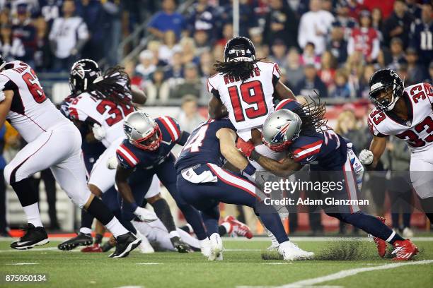 Andre Roberts of the Atlanta Falcons is tackled by Brandon Bolden of the New England Patriots during a game at Gillette Stadium on October 22, 2017...