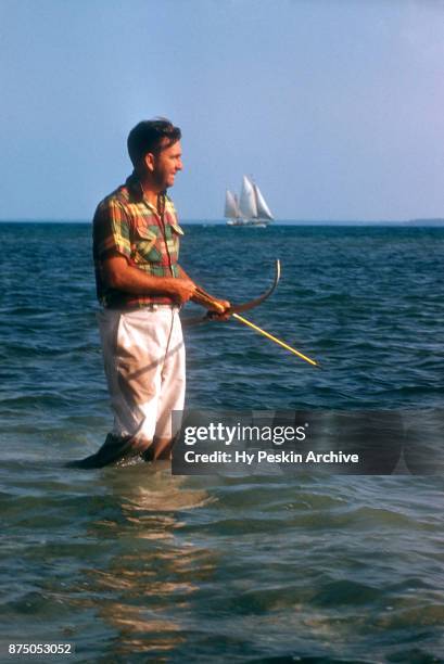 Colyn Rees uses his bow and arrow as he hunts for fish on April 7, 1956 in the Bahamas.