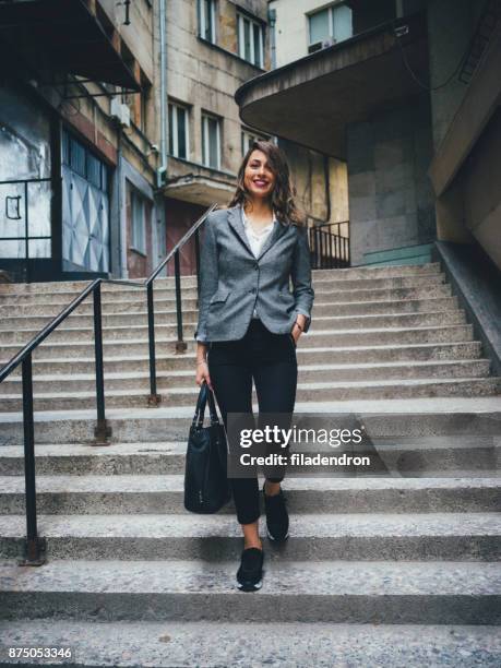 femme marche dans les escaliers - mains dans les poches photos et images de collection