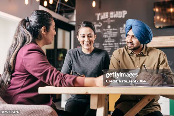 couple and financial advisor - sikhism stock pictures, royalty-free photos & images