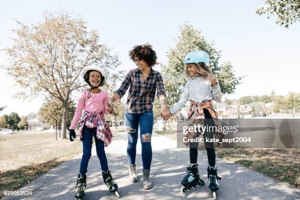 happy siblings on rollerblades - 10-15 2004 stock pictures, royalty-free photos & images