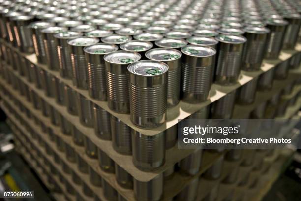 cans of peas and carrots sit stacked on a pallet - in konserve abfüllen stock-fotos und bilder
