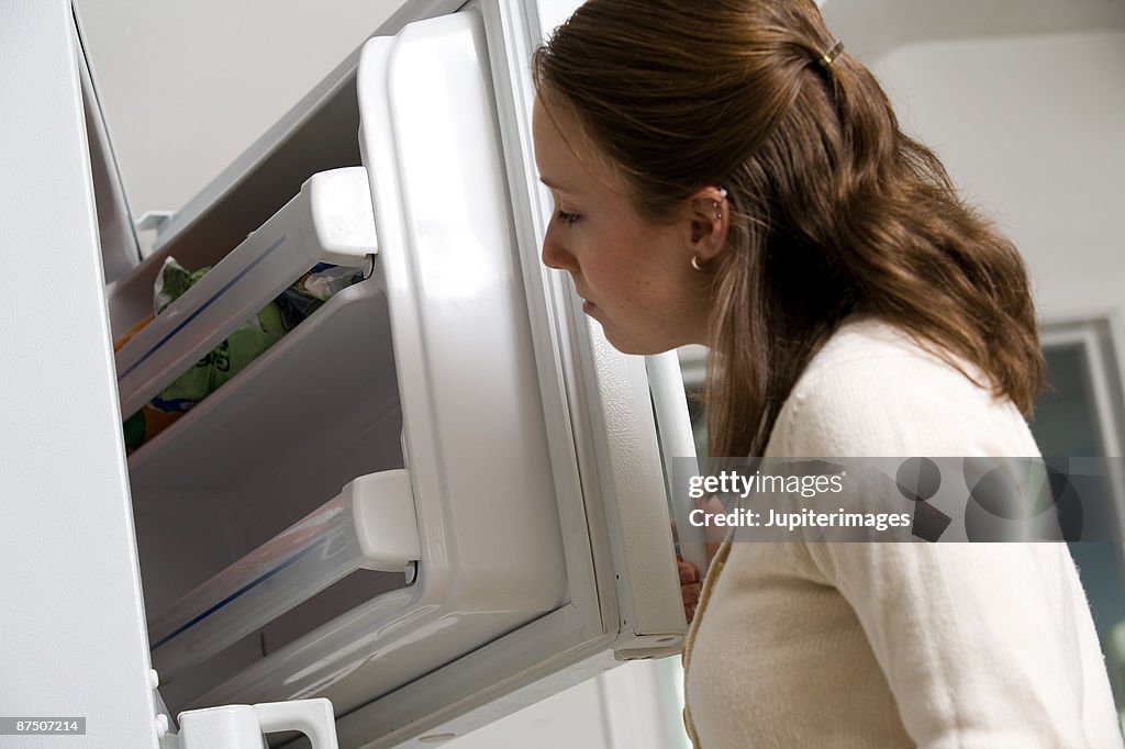 Woman looking in freezer