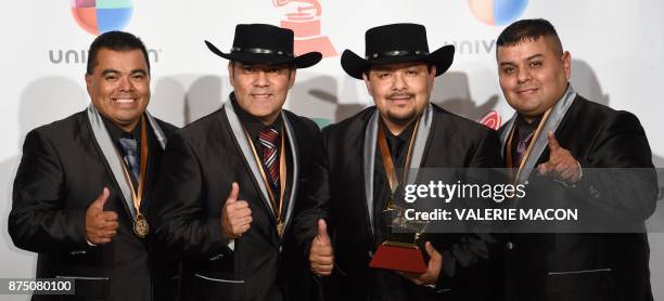 Los Palominos pose with the trophy for Best Norteño Music Album during the 18th Annual Latin Grammy Awards in Las Vegas, Nevada, on November 16,...