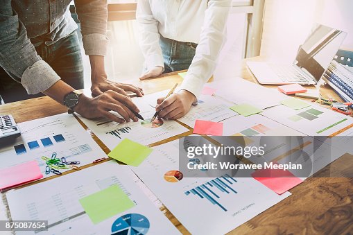 Close up Business woman and partner pointing at paperwork and finance, tax, accounting, statistics and analytic research, group support and meeting concept Close up Business woman and partner pointing at paperwork and finance, tax, accounting, statistics and analytic research, group support and meeting concept