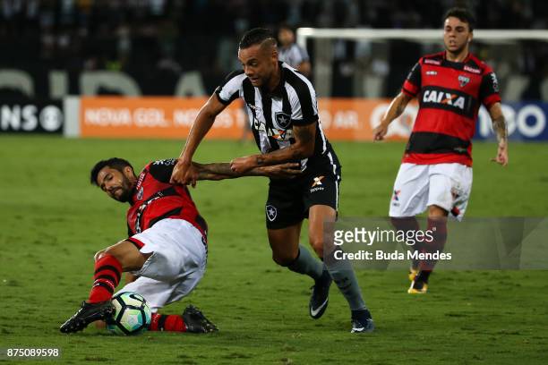 Guilherme of Botafogo struggles for the ball with Jonathan of Atletico GO during a match between Botafogo and Atletico GO as part of Brasileirao...