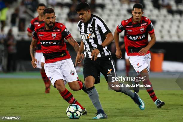 Brenner of Botafogo struggles for the ball with William Alves of Atletico GO during a match between Botafogo and Atletico GO as part of Brasileirao...