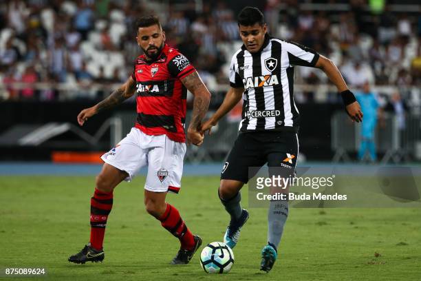 Brenner of Botafogo struggles for the ball with William Alves of Atletico GO during a match between Botafogo and Atletico GO as part of Brasileirao...