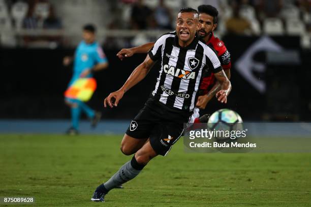 Guilherme of Botafogo struggles for the ball with Jonathan of Atletico GO during a match between Botafogo and Atletico GO as part of Brasileirao...