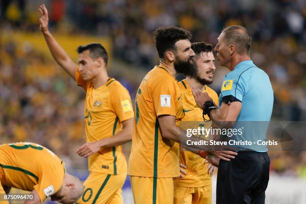 Mile Jedinak of the Australia is held back by referee Nestor Fabian Pitana during the 2nd leg of the 2018 FIFA World Cup Qualifier between the...