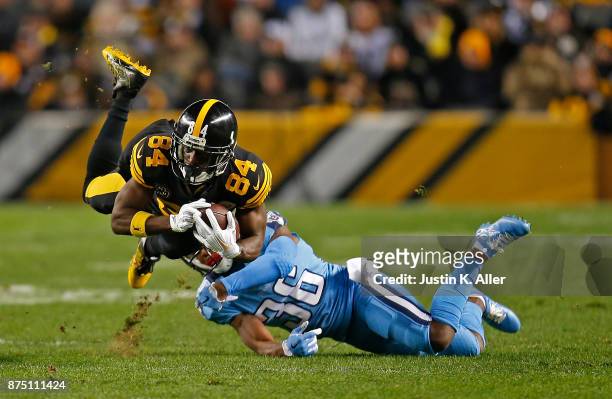 Antonio Brown of the Pittsburgh Steelers is tripped up for a tackle by LeShaun Sims of the Tennessee Titans in the first quarter during the game at...