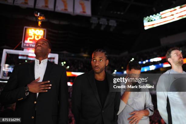 Former Spurs David Robinson with Kawhi Leonard of the San Antonio Spurs and his teammates stand for the National Anthem before the game against the...