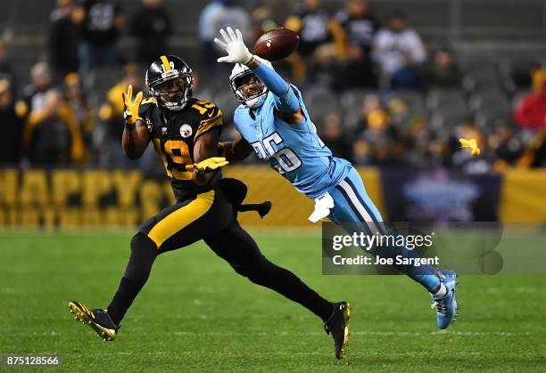 Logan Ryan of the Tennessee Titans knocks the ball away from JuJu Smith-Schuster of the Pittsburgh Steelers as he tries to make a catch in the first...