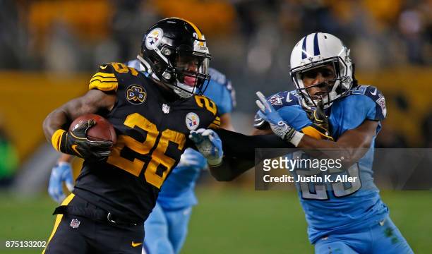 Le'Veon Bell of the Pittsburgh Steelers carries the ball as he stiff arms Adoree' Jackson of the Tennessee Titans in the second half during the game...