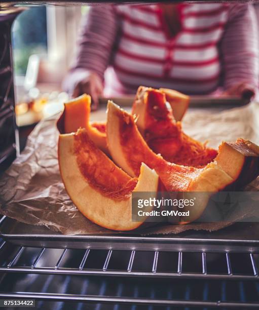 roasting pumpkins in the oven - hokaido pumpkin stock pictures, royalty-free photos & images
