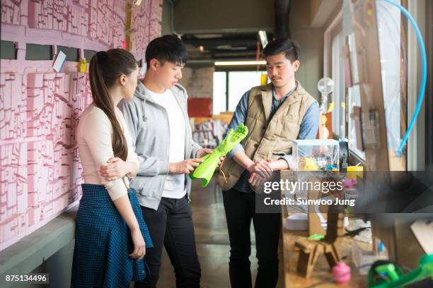 engineers discussing project in workshop - korea technology stock pictures, royalty-free photos & images