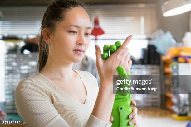 engineer examining robotics in workshop - biomedical engineering photos et images de collection