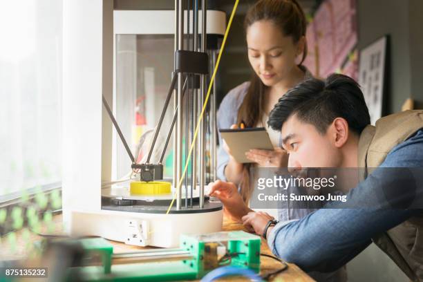 focused engineers prototyping project on 3d printer - korea technology stock pictures, royalty-free photos & images