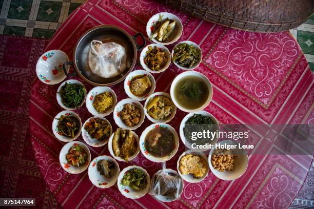 food is offered to monks in pagoda at shwe paw island on ayeyarwady (irrawaddy) river, shwegu, kachin, myanmar - myanmar food stock pictures, royalty-free photos & images