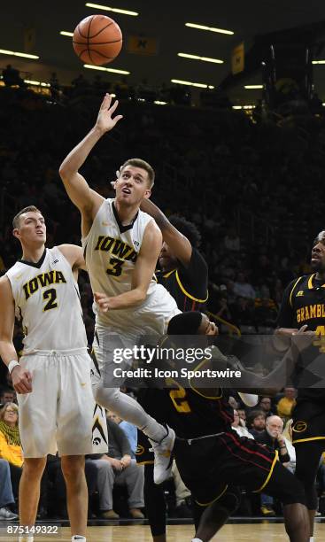 Iowa guard Jordan Bohannon is fouled by Grambling State guard Nigel Riberio as he shoots during a non-conference college basketball game between the...