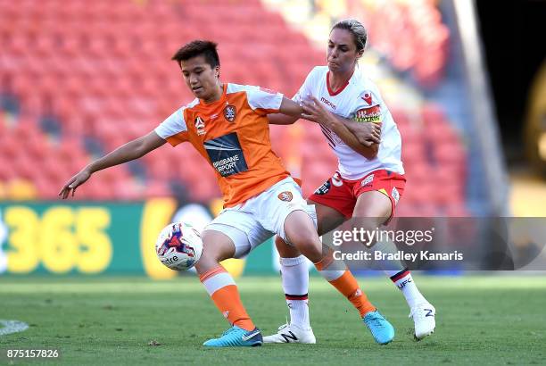 Wai Ki Cheung of the Roar is challenged by Emma Checker of Adelaide United during the round four W-League match between Brisbane and Adelaide at...