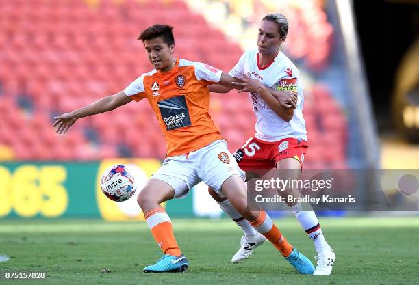 Wai Ki Cheung of the Roar is challenged by Emma Checker of Adelaide United during the round four W-League match between Brisbane and Adelaide at...