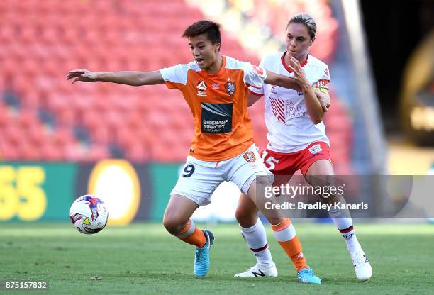 Wai Ki Cheung of the Roar is challenged by Emma Checker of Adelaide United during the round four W-League match between Brisbane and Adelaide at...