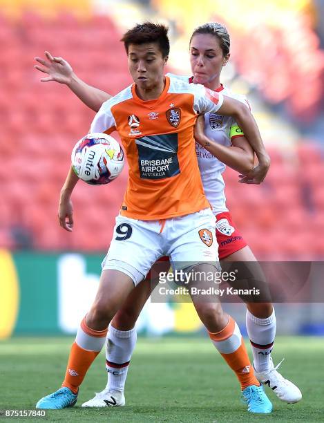 Wai Ki Cheung of the Roar is challenged by Emma Checker of Adelaide United during the round four W-League match between Brisbane and Adelaide at...